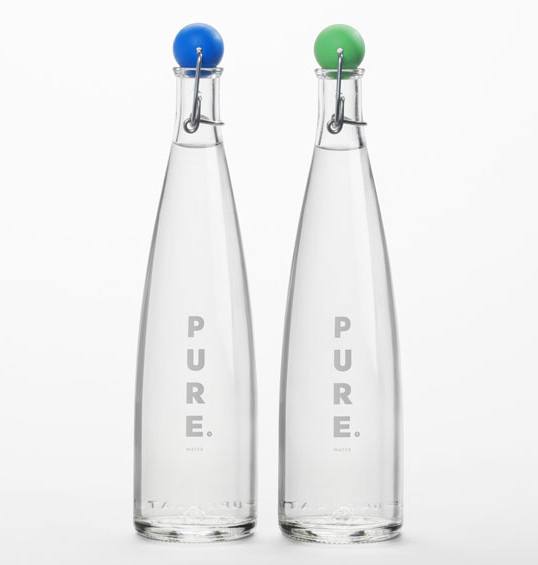 Two tall, clear glass bottles with the word 